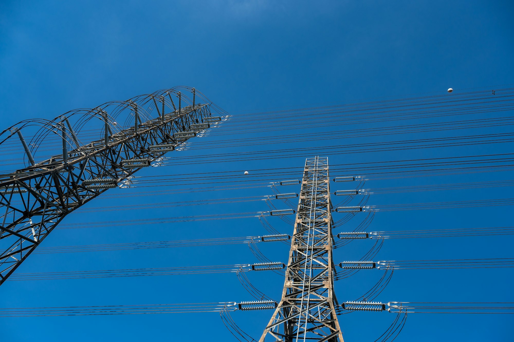 Closeup of communication and satellite tower with connecting wires transferring electricity