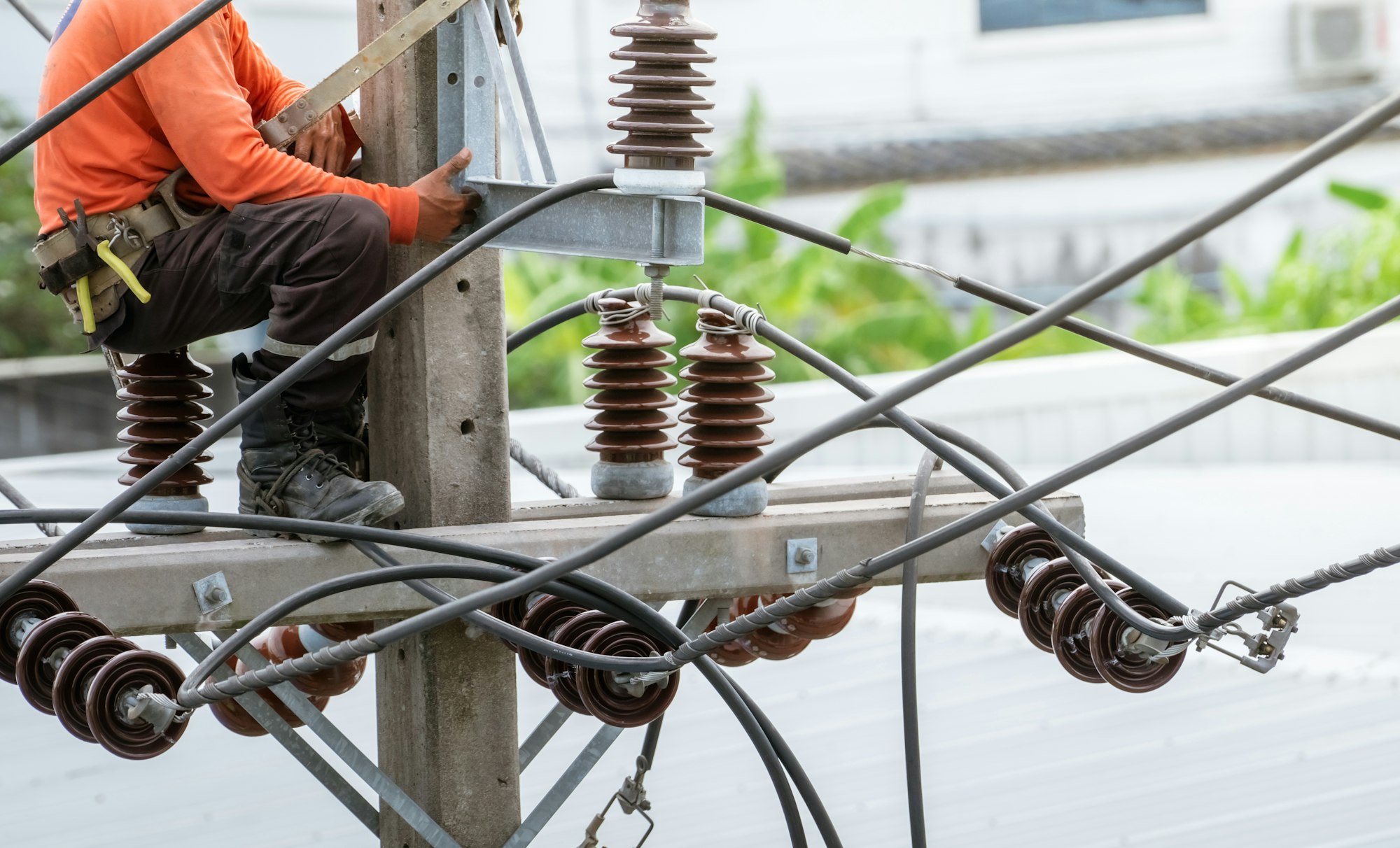 High voltage power line maintenance. Electrician at work. Electrical technician working on electric
